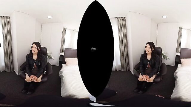 Stunning Asian beauty in leather jacket sits sexy on chair in JAV room