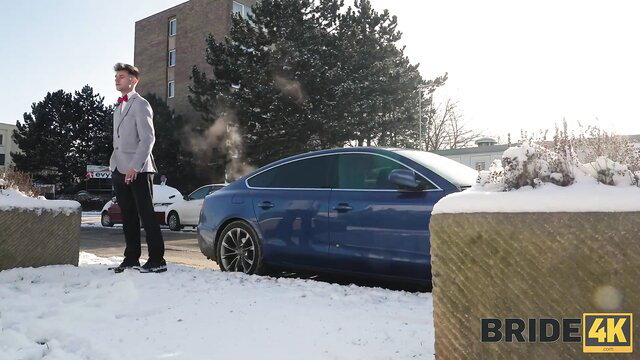 Sofia Lee as sexy bride in gray suit bowtie poses by blue car pre-wedding