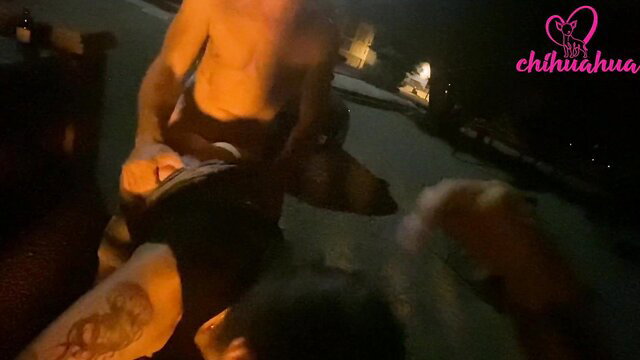 Muscular tanned man in speedo grabs dog by pool at night, wild Croatia BTS