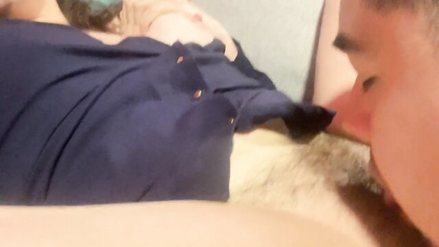 Man licks wet pussy of woman in navy dress on bed closeup