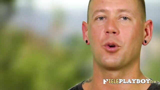 Bald muscular man with earrings speaking outdoors in swinger lust house