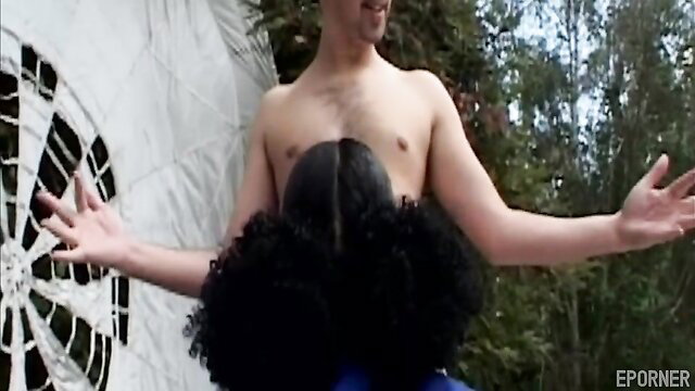 Ebony woman with afro rides nude guy outdoors by dartboard