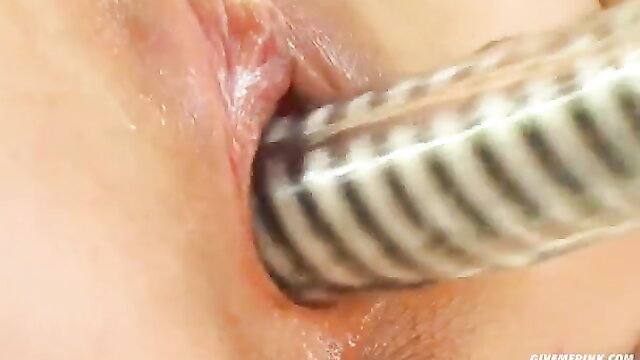 Slut in stockings drills pussy with huge hose toy closeup