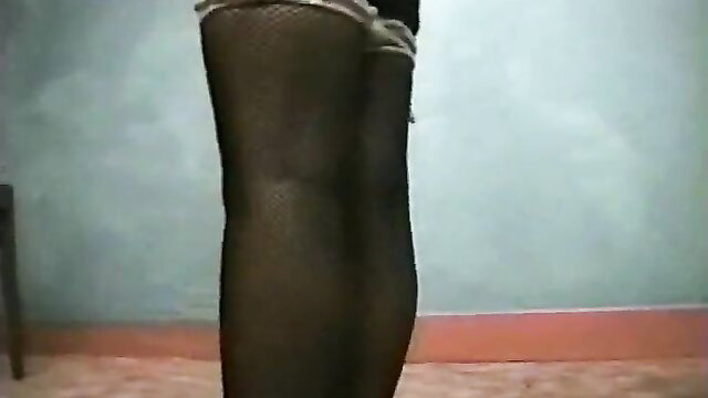 Submissive hottie in black fishnet stockings bound and legs spread