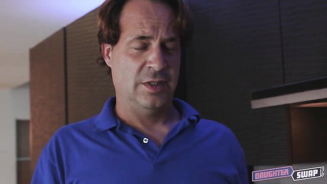 Man in blue polo shirt talks intently in Daughter Swap scene