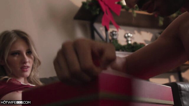 Hot blonde Melody Marks in red dress by Christmas tree