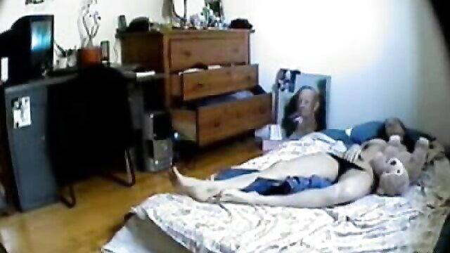 Amateur woman in black panties masturbates on bed to orgasm