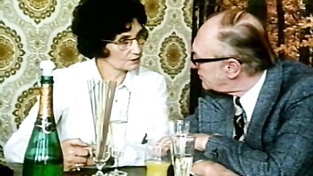 Vintage 70s couple toasting champagne in retro porn scene