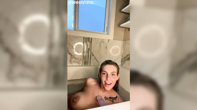 Roxystylezz naked in bathtub smiling, wet blonde tits exposed