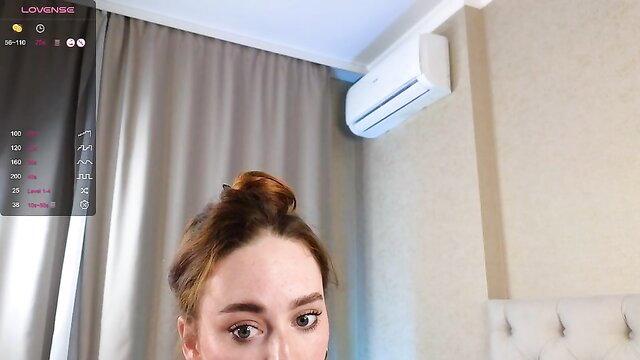 Raunchy webcam girl with bun hairstyle closeup tease