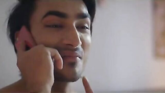 Handsome Indian college boy on phone call, smirking playfully