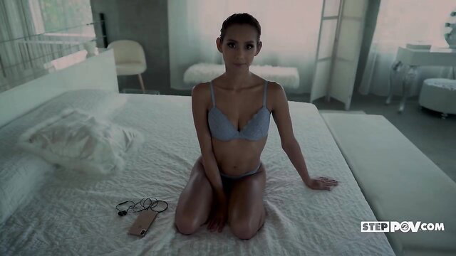 Veronica Leal in sexy blue lingerie kneeling on bed