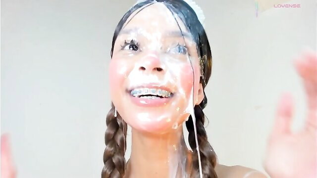 Asian bimbo with pigtails covered in thick cum facial smiling