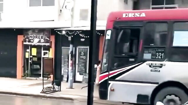 Red DERSA bus parked at Horeb store, public degeneracy scene