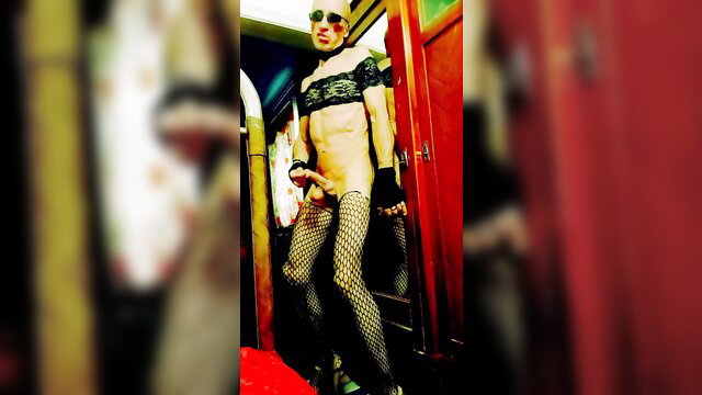 Bald crossdresser in lingerie stockings exposes cock in doorway