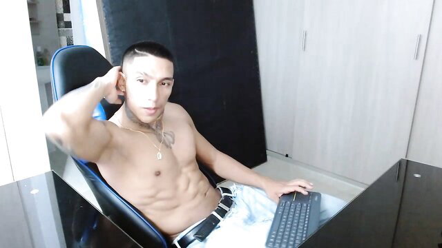 Colombian muscled hunk shirtless in chair, oil show tease