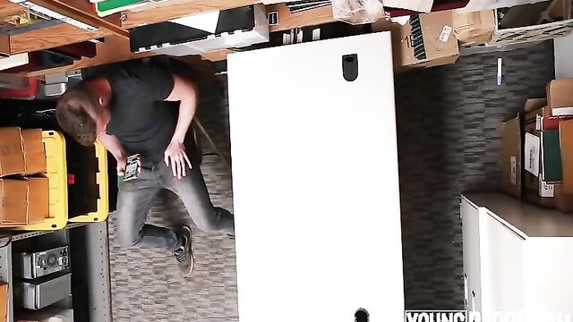 Young fit hetero guy kneeling in office, jeans low, huge bulge visible