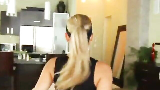 Blonde ponytail babe in tank top sits in kitchen, hot body tease