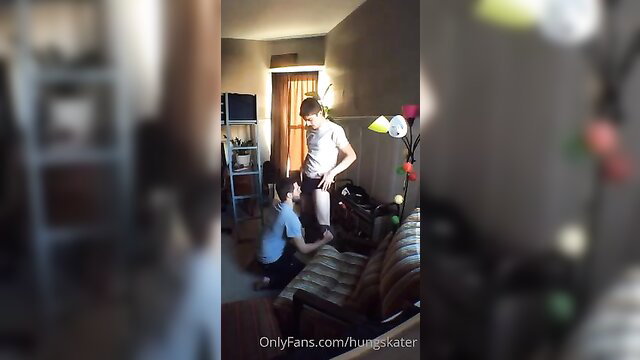 Hung skater stands over kneeling guy in explicit gay encounter