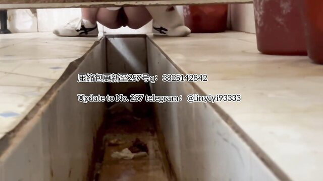 Beautiful Asian girl squatting over drain pooping, bare ass visible