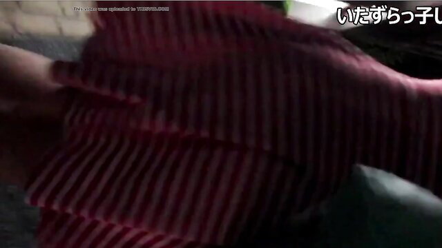 Asian amateur lifts red striped skirt for upskirt panty tease at night