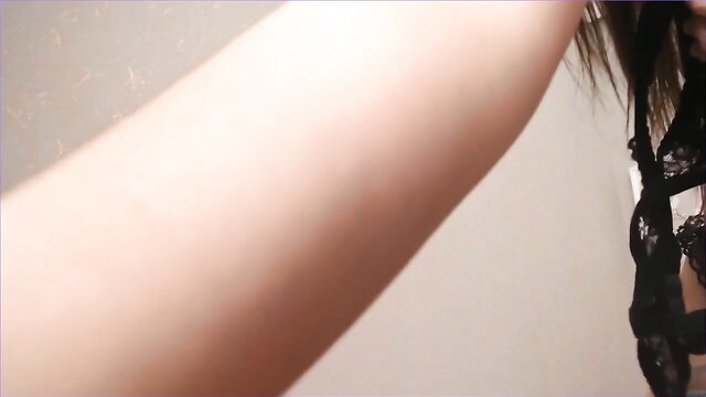 Busty Japanese cam girl arm in black lace lingerie dirty dance