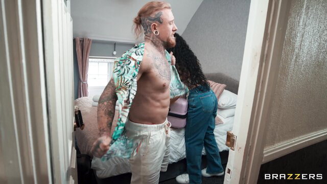 Redhead tattooed man with curvy black woman in doorway at Danny's stay