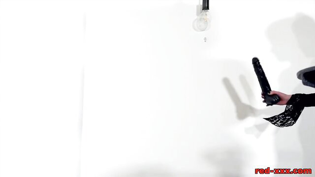 Kinky redhead GILF in lingerie holds black dildo solo tease