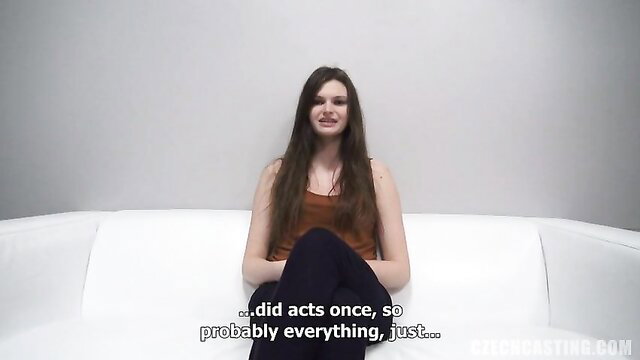 Amateur Klara in tank top and leggings on couch, smiling shyly