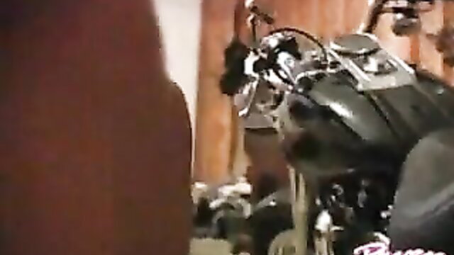 Raven Riley poses sexy by Harley motorcycle in tight top