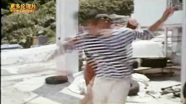 Two Asian men in striped shirts wrestling erotically outdoors