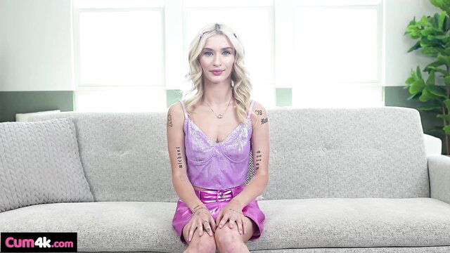 Emma Rosie in purple lingerie on sofa, teasing blowjob preview