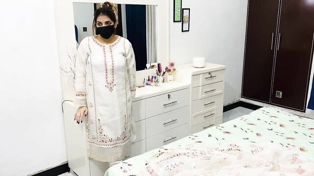 Sara Khan in white embroidered salwar kameez and mask in bedroom