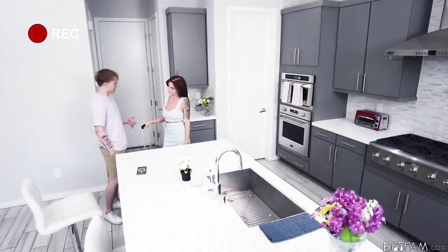 Hot tattooed stepsister in white dress chats with stepbro in kitchen