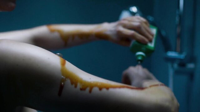 Eva Green nude in shower, bloodied arms, pouring green liquid, Proxima 2019