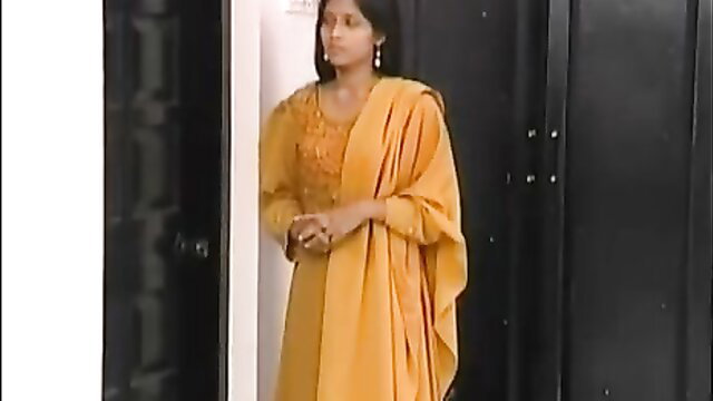 Stunning Indian beauty in yellow salwar kameez posing seductively