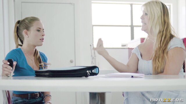 Two busty blondes in tight tops talking intimately at desk, Brazzers sneaky sex tease