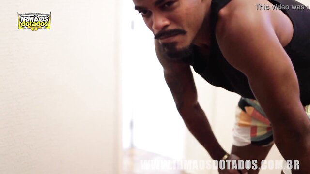 Muscular black man in tank top and shorts, intense bareback step cousins preview