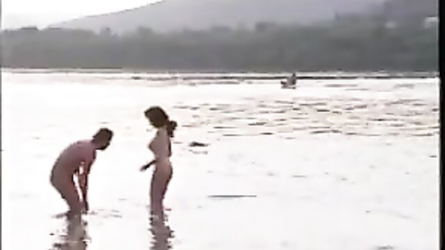 Nude brunette bending over man in river, anal massage tease