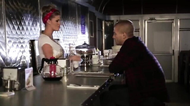 Blonde waitress in red bandana serves busty cleavage to bald man at diner counter