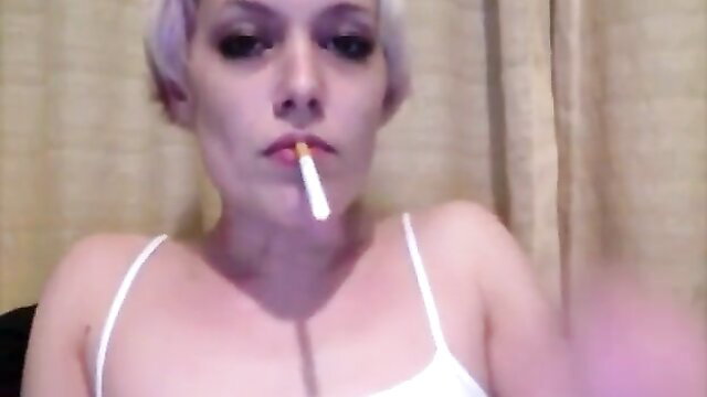 Hot platinum blonde smokes cigarette in tight white tank top closeup