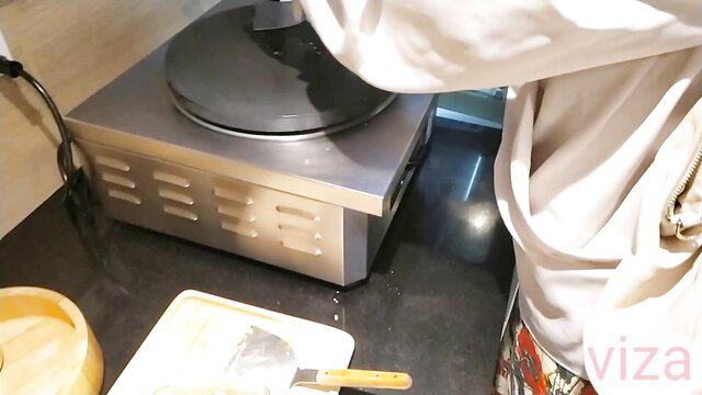 Thai chef girl in white uniform cooking on hot plate in amateur sex vlog