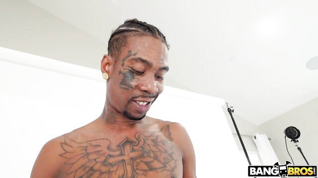 EboBlack shirtless with face tats and wing chest ink in studio shoot
