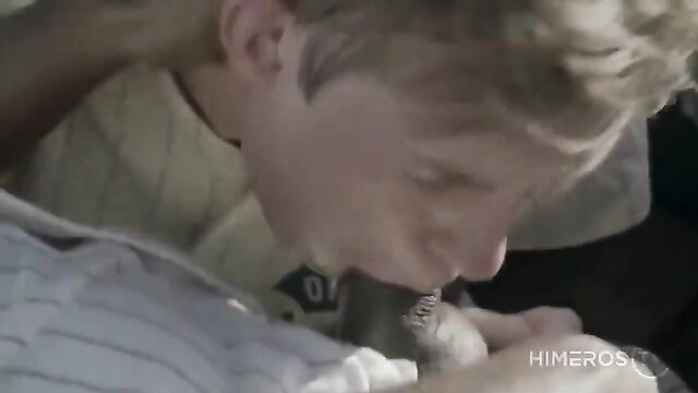 Young blond guy sucking coach's cock in baseball uniform