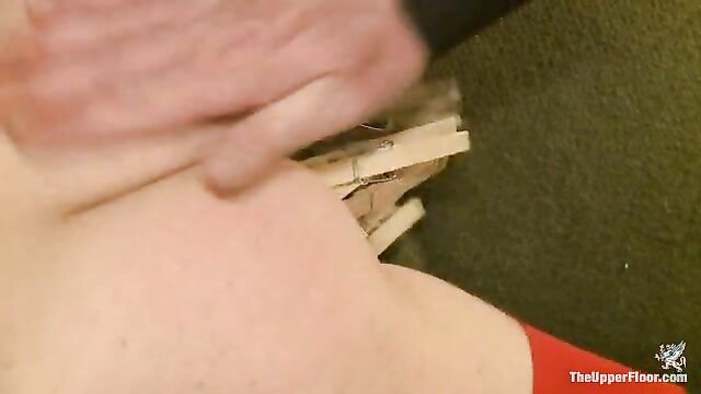 Cute slave watches friends' lusty fun with clothespins on pussy