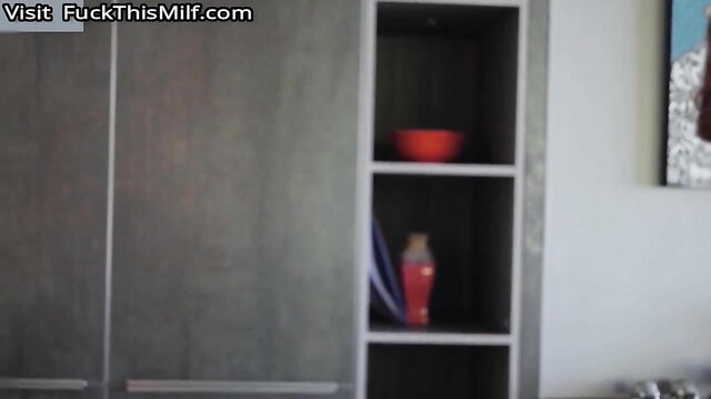 Sexy Android model in gray wardrobe with red bowl and vase, erotic pose