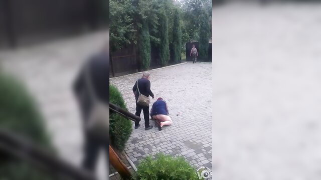 Drunk mature woman collapses on knees, helpless in skirt outdoors