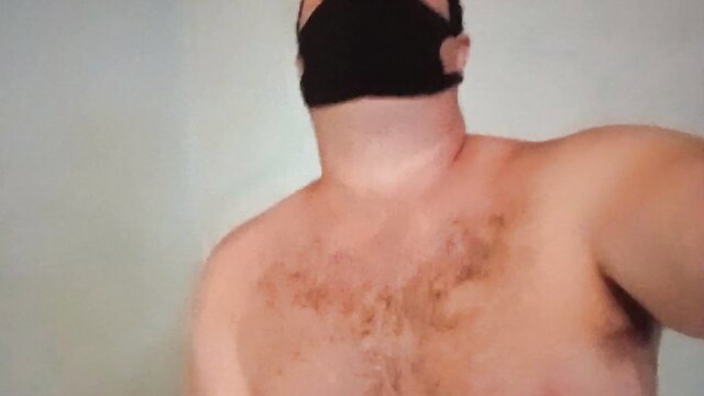 Hairy mature man shirtless in black face mask, closeup neck and chest