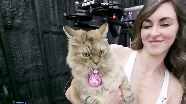 Bryce Adams holds cat in tank top on $500K home gym tour