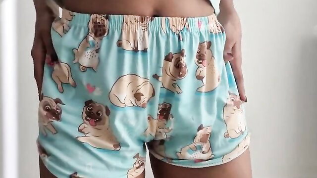 Sexy ebony babe in cute pug print shorts showing toned abs